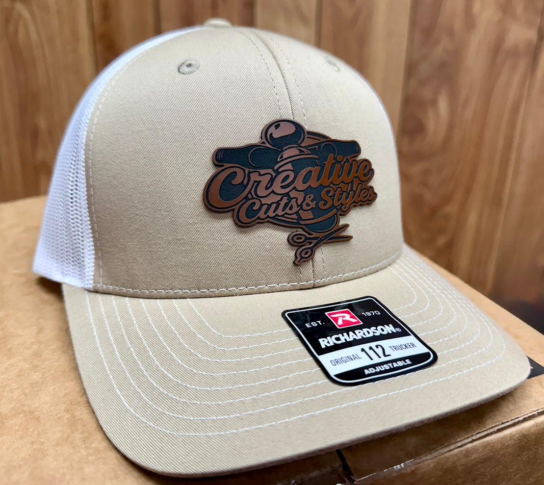 Beige cap with a logo and Richardson label on a wooden surface